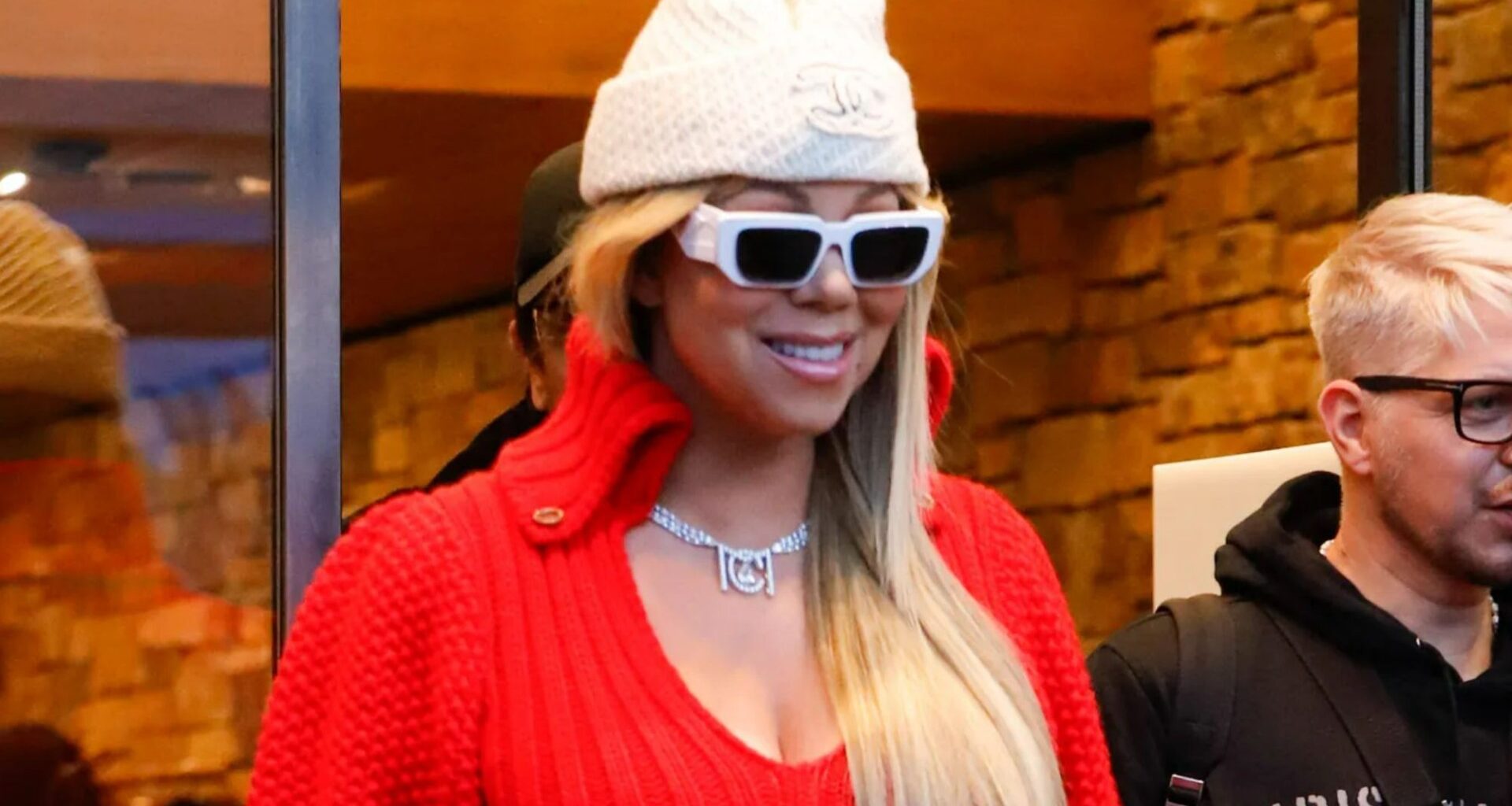 Mariah Carey gets into the festive spirit in a short red dress and white boots in Aspen