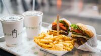 Shake Shack burgers, fries, and shakes on table