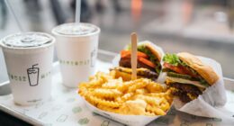 Shake Shack burgers, fries, and shakes on table