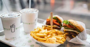 Shake Shack burgers, fries, and shakes on table