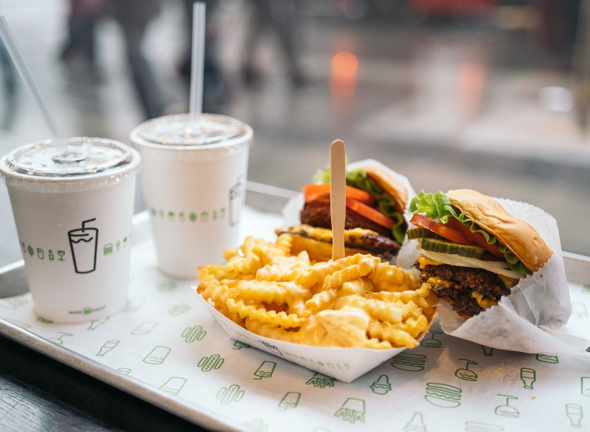 Shake Shack burgers, fries, and shakes on table