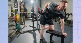 fitness man doing dumbbell row at the gym