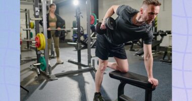 fitness man doing dumbbell row at the gym