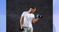 fit man lifting dumbbells in front of black backdrop