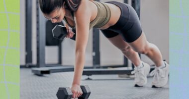 fit brunette woman doing dumbbell renegade row exercise