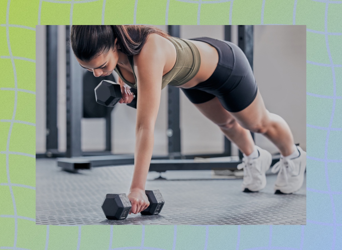 fit brunette woman doing dumbbell renegade row exercise