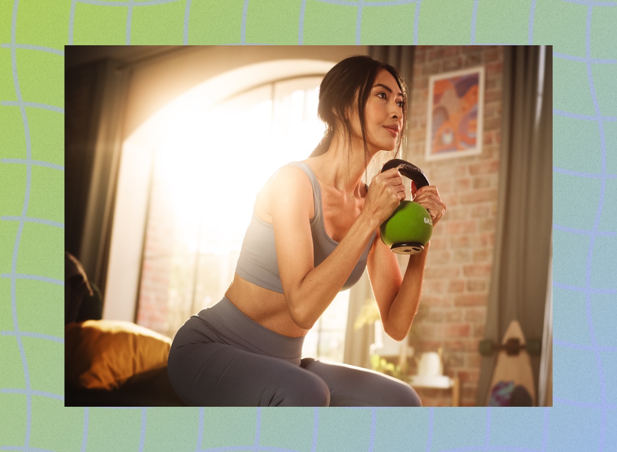 fit woman doing kettlebell goblet squat in bedroom