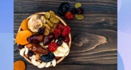 close-up of bowl of dried fruit and nuts on wooden table