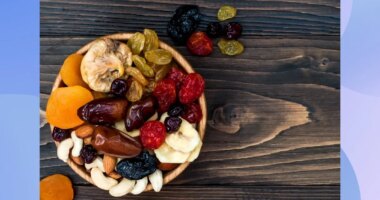 close-up of bowl of dried fruit and nuts on wooden table