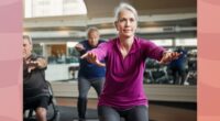 fit, mature woman doing squats in group fitness class at the gym