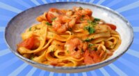 A plate of seafood pasta set against a vibrant background.