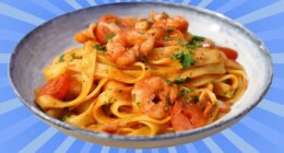 A plate of seafood pasta set against a vibrant background.