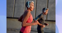 fit, focused mature woman running outdoors