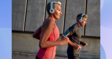 fit, focused mature woman running outdoors