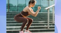 fit, focused woman doing bodyweight squats outdoors near set of stairs