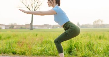 woman doing squats, concept of workouts that burn the most fat