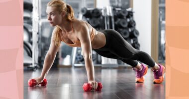 fit blonde woman doing dumbbell renegade row or pushup in gym