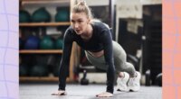 focused blonde woman doing high plank or pushup at the gym