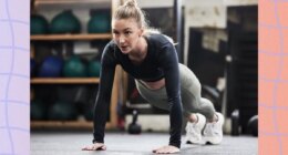 focused blonde woman doing high plank or pushup at the gym