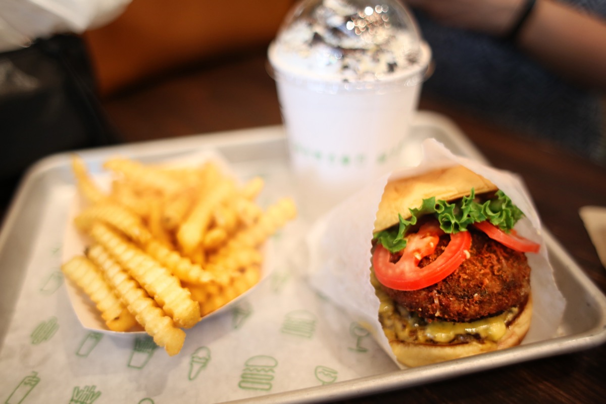 Cheeseburger with French Fries and Milkshake Meal on Tray Fast Food.