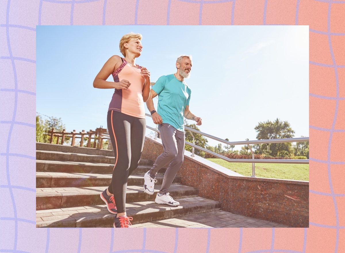 fit, mature couple running outdoors down stairs for exercise on sunny summer day