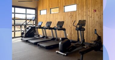 lineup of cardio machines in a gym