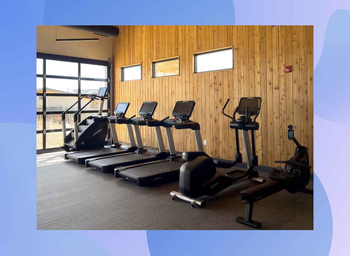 lineup of cardio machines in a gym