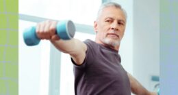 fit, mature man focused while doing a dumbbell lateral raise exercise