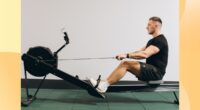 fit man rowing in gym