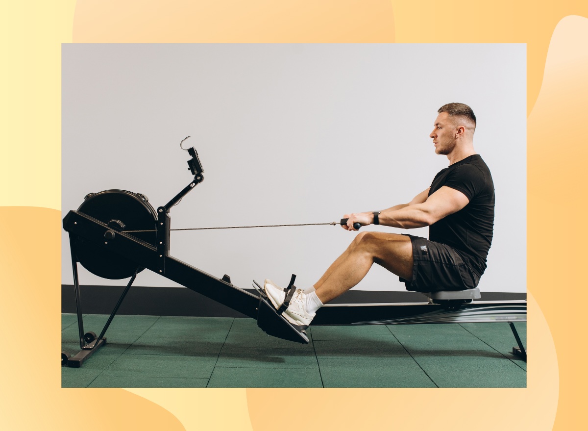 fit man rowing in gym