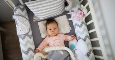 Why the celebrity-backed 'designer' baby cot trend could be lethal: Experts warn over craze for decorating newborns' cribs with pillows and plush toys - and what you should do instead