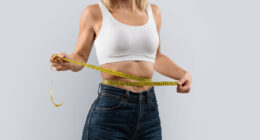 woman measuring her waistline, concept of tips for women to achieve lasting weight loss after 40