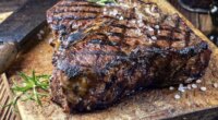 dry ages barbecue porterhouse steak on cutting block