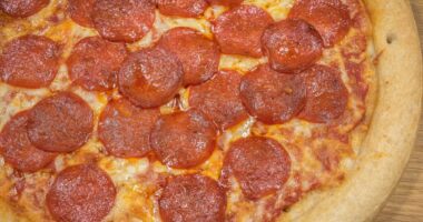 Pepperoni Pizza Up Close Studio Shot against a wooden background