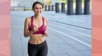 fit, happy brunette woman running outdoors