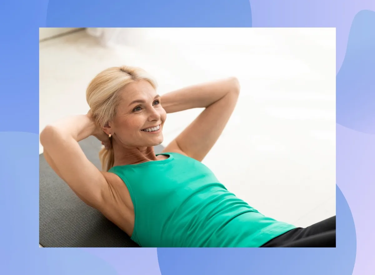 mature blonde woman doing sit-ups at home on yoga mat