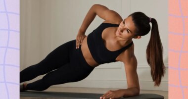 fit woman doing side plank exercise on mat