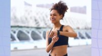 happy woman checking her fitness tracker while outdoors on a walk