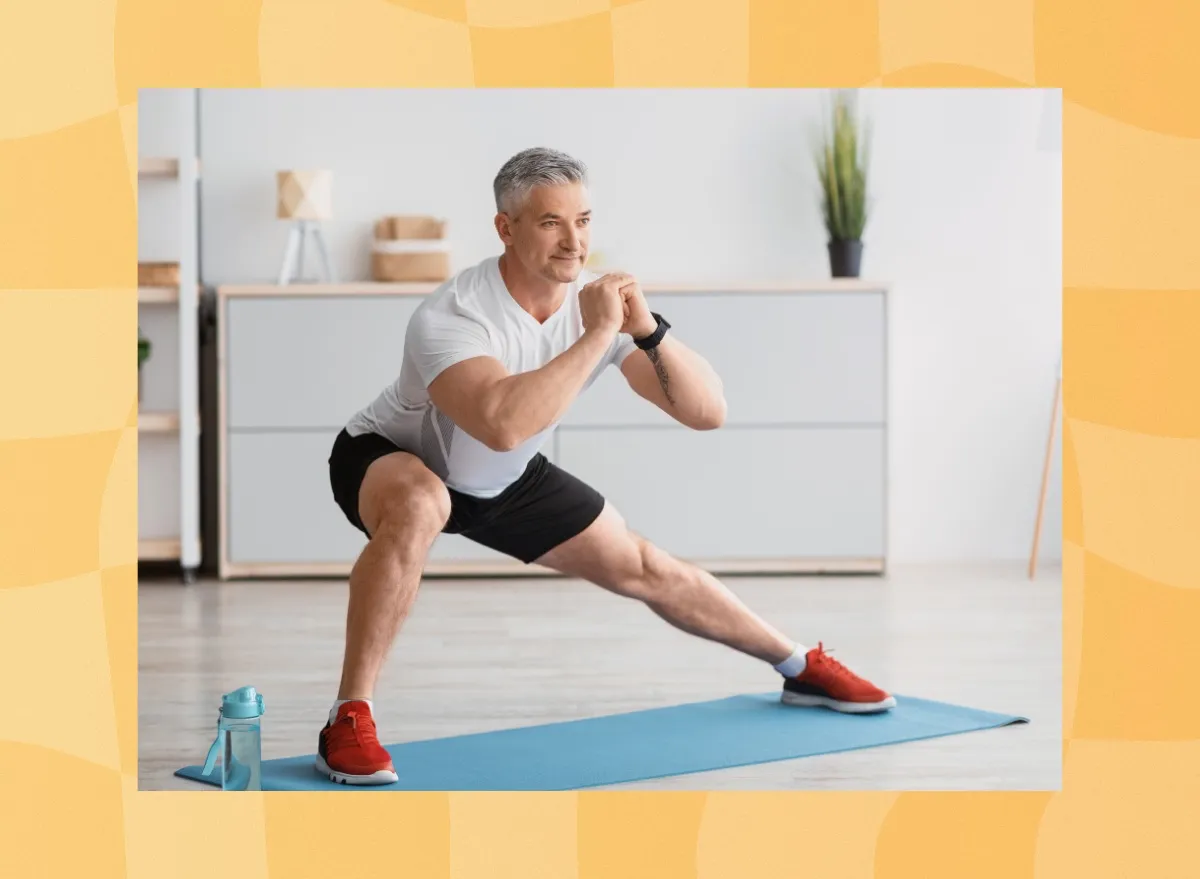 fit, mature man doing side lunges at home on yoga mat in bright living space